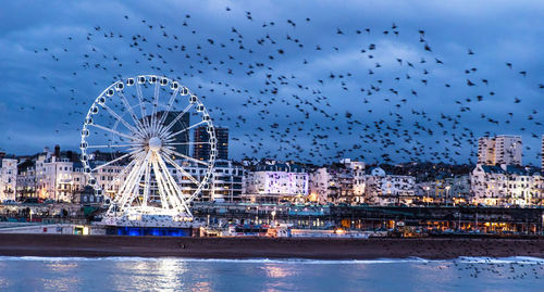 Ferris wheel against sky at night