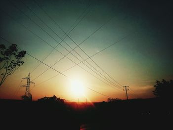 Silhouette trees against sky during sunset