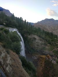 Scenic view of river amidst mountains against sky