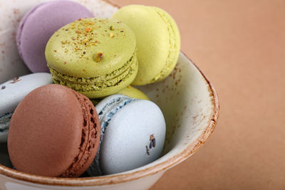 Close-up of colorful macaroons in bowl