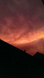 Silhouette of mountain against dramatic sky