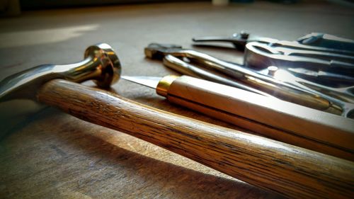 Close-up of hand tools on table at workshop