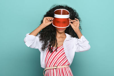 Woman holding coffee cup against white background