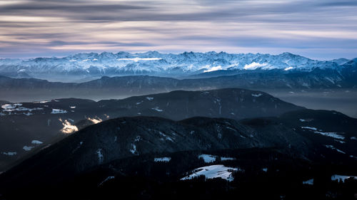 Scenic view of mountains against cloudy sky