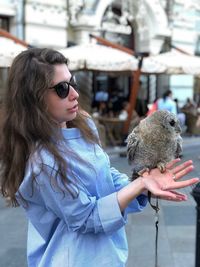 Young woman with sunglasses in city