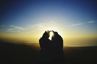 Silhouette of people at sunset