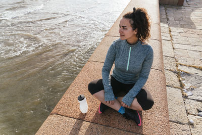 Young woman sitting after workout