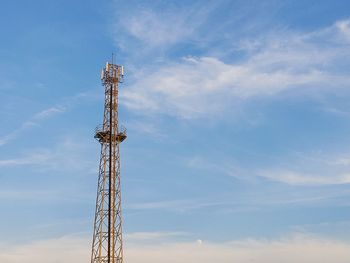 Low angle view of communications tower against sky