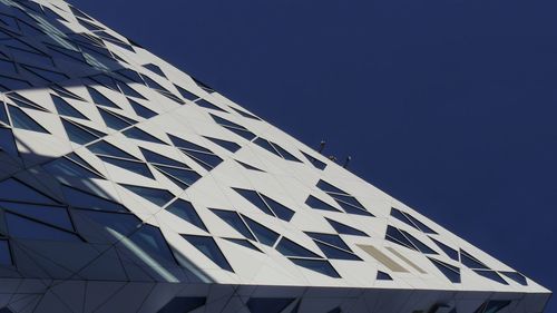 Low angle view of building against clear blue sky