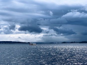 Scenic view of sea against storm clouds