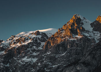 Scenic view of snowcapped mountains against clear sky