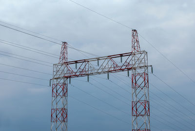 Low angle view of cranes against sky