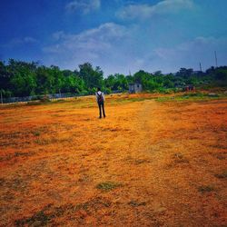 Man on field against sky