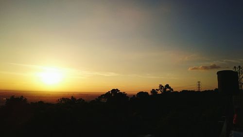 Silhouette trees against sky during sunset