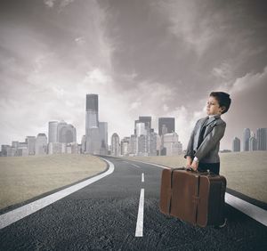 Man on road against buildings in city