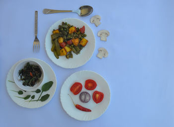 High angle view of chopped fruits in plate on table