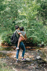 Rear view of women walking in forest