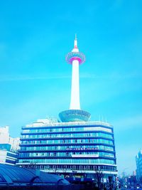 Low angle view of skyscrapers against blue sky