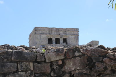 Low angle view of old ruins against clear blue sky