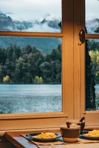 Breakfast served on table with beautiful view through window