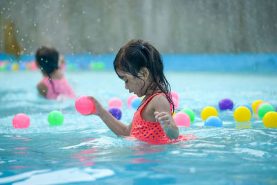 Girl playing in swimming pool