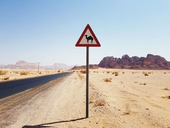 Road sign against clear sky