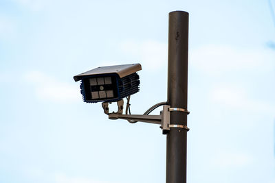 Low angle view of street light against sky