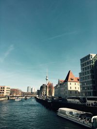 Spree river in city against sky
