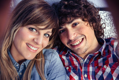 Portrait of cheerful couple at home