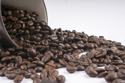 Close-up of roasted coffee beans against clear sky