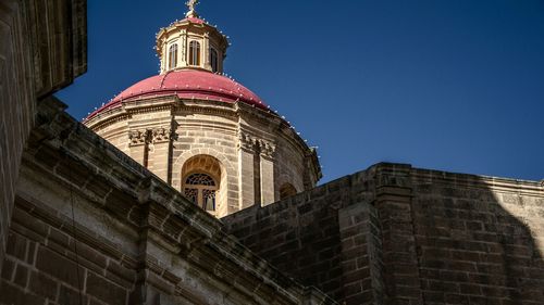 Low angle view of church against blue sky