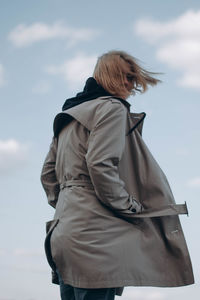 Rear view of woman standing against sky