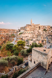 Wide view of the sassi di matera from the belvedere colombo blue sky with clouds, vertical