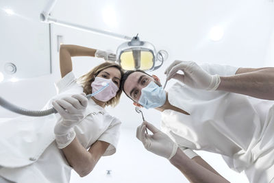 Cropped hand of doctor holding dentures