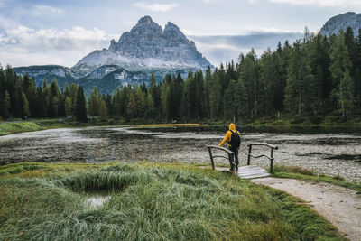 Man standing by plants against mountains