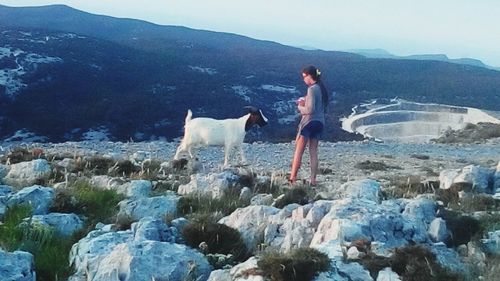 Woman standing on rocks at beach