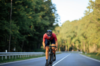 Man riding bicycle on road