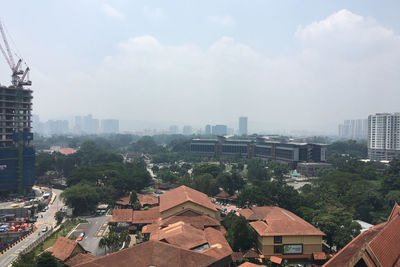 High angle view of buildings in city against sky