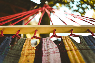 Low angle view of clothespins hanging on rope