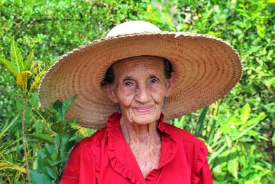 Close-up portrait of senior woman wearing hat at farm