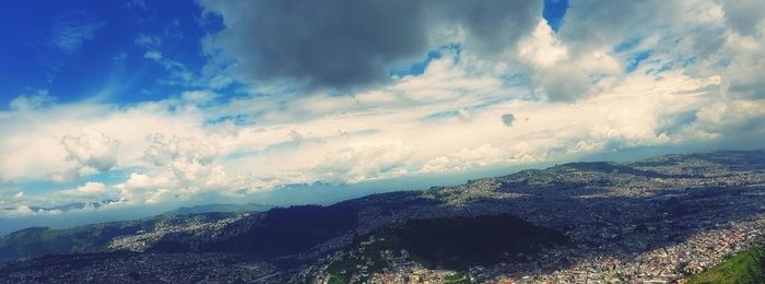 Scenic view of sea and mountains against sky