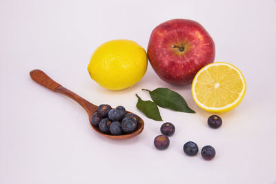 Fruits on table against white background