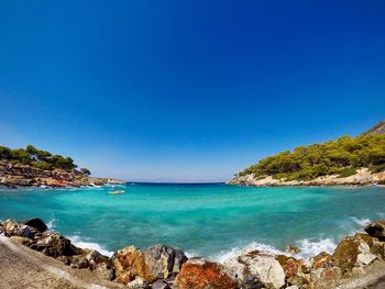 Scenic view of sea against clear blue sky