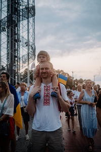  ukraine's independence day. anti-war rally in georgia. ukrainian flag, father with daughter refugees 