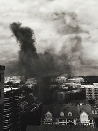Buildings against cloudy sky