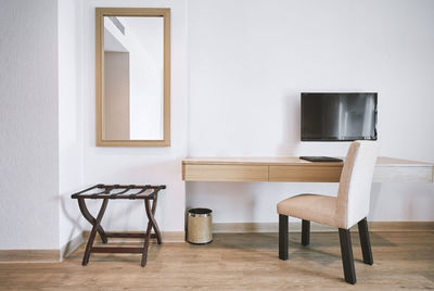 Empty chair and table in living room at home