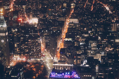 High angle view of city lit up at night