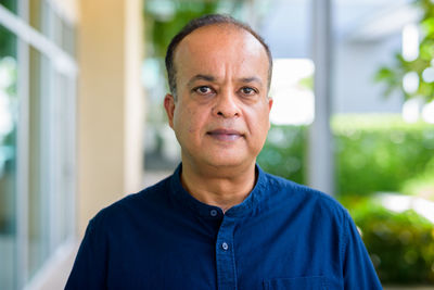 Portrait of man against blue wall