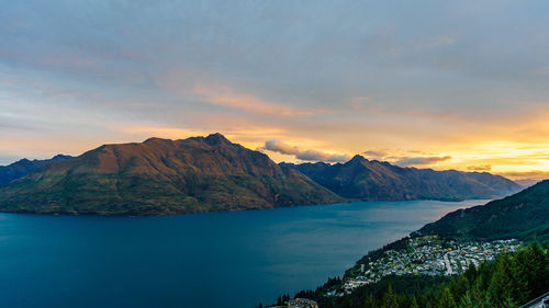 Scenic view of sea and mountains against sky during sunset