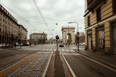 Road amidst buildings in city